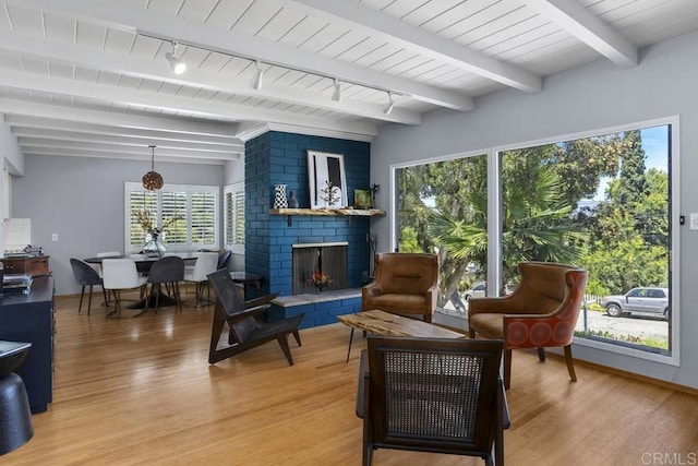 1001 Ontario St, Escondido, CA 92025 - sitting room featuring light wood finished floors, plenty of natural light, a fireplace, and beam ceiling
