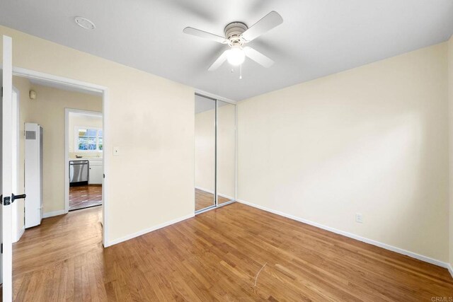 4920 Elsa Rd, San Diego, CA 92120 - unfurnished bedroom with a heating unit, a closet, wood finished floors, and a ceiling fan