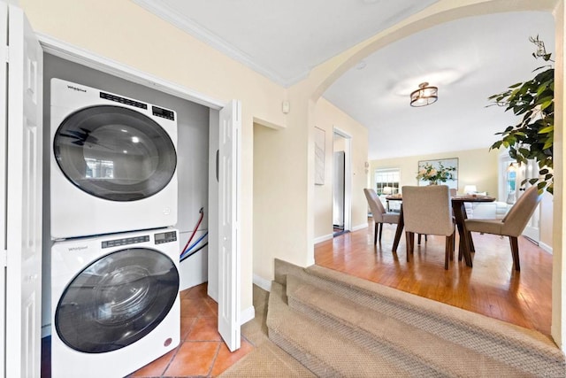 4920 Elsa Rd, San Diego, CA 92120 - laundry room with stacked washer / dryer, arched walkways, and crown molding