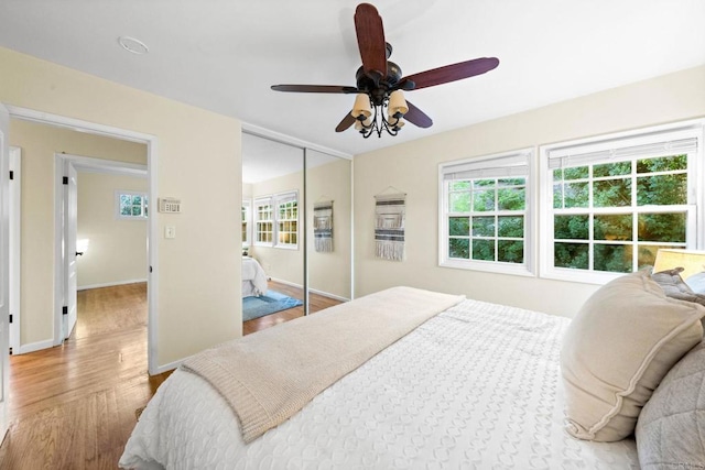 4920 Elsa Rd, San Diego, CA 92120 - bedroom featuring multiple windows, wood finished floors, a closet, and ceiling fan