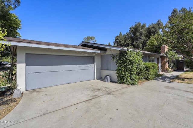 929 Diamond St, Monrovia, CA 91016 - view of front facade featuring driveway, an attached garage, and stucco siding