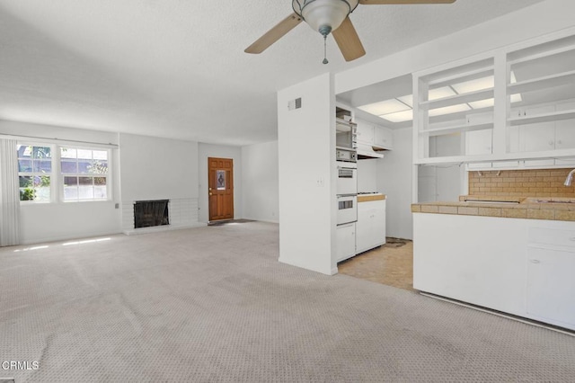 929 Diamond St, Monrovia, CA 91016 - unfurnished living room featuring light carpet, a ceiling fan, and a fireplace