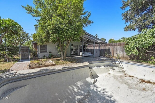 929 Diamond St, Monrovia, CA 91016 - view of property hidden behind natural elements with a gate, stucco siding, and a patio