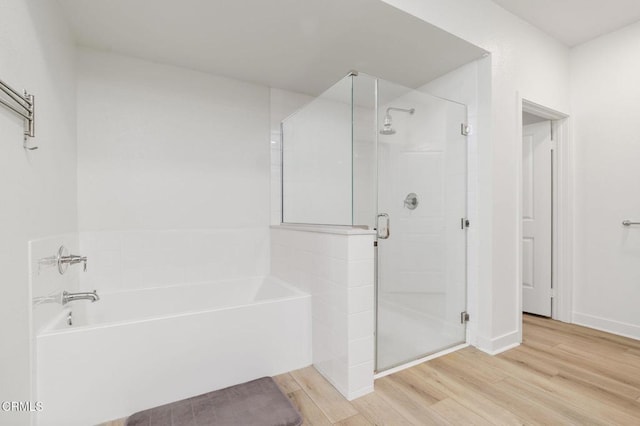 2850 Wagon Wheel Rd Unit 402, Oxnard, CA 93036 - bathroom featuring a garden tub, wood finished floors, and a shower stall