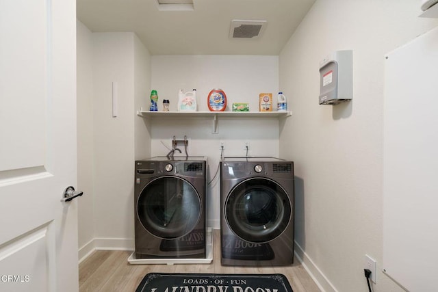 2850 Wagon Wheel Rd Unit 402, Oxnard, CA 93036 - washroom with washer and dryer and wood finished floors