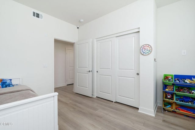 2850 Wagon Wheel Rd Unit 402, Oxnard, CA 93036 - bedroom featuring light wood-type flooring and a closet