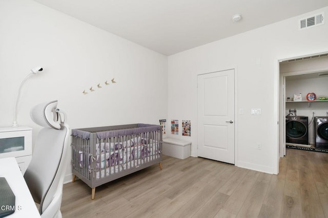 2850 Wagon Wheel Rd Unit 402, Oxnard, CA 93036 - bedroom featuring wood finished floors, independent washer and dryer, and a nursery area