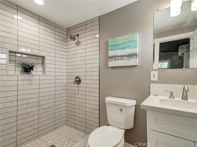 2310 W 169th Pl, Torrance, CA 90504 - full bathroom with vanity, tiled shower, and a textured wall