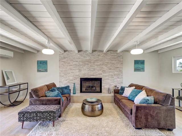 2310 W 169th Pl, Torrance, CA 90504 - living room with wood finished floors, a wall mounted air conditioner, beamed ceiling, and a stone fireplace