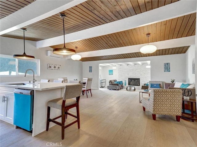 2310 W 169th Pl, Torrance, CA 90504 - kitchen featuring dishwashing machine, beamed ceiling, open floor plan, light wood-style flooring, and hanging light fixtures