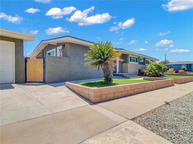 2310 W 169th Pl, Torrance, CA 90504 - view of front of home with a gate and stucco siding