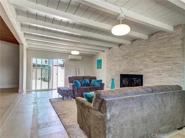 2310 W 169th Pl, Torrance, CA 90504 - living area featuring a wall mounted AC, a wooden ceiling with exposed beams, a stone fireplace, and hardwood / wood-style floors