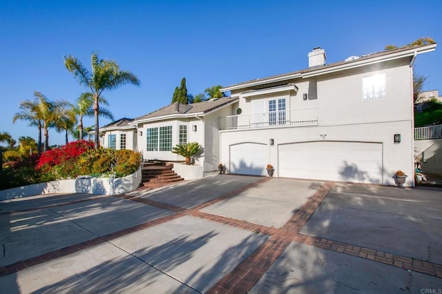 1248 Via Christina, Vista, CA 92084 - view of front of house featuring an attached garage, concrete driveway, a balcony, a chimney, and stucco siding