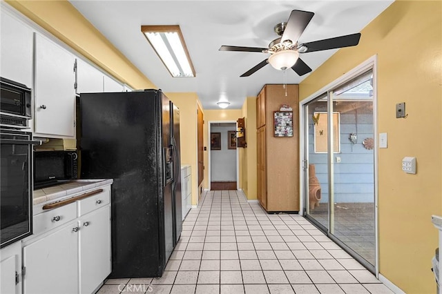 603 Reed Park Dr, Chico, CA 95926 - kitchen with tile counters, black appliances, white cabinetry, and ceiling fan