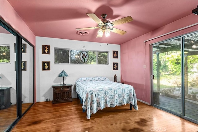 603 Reed Park Dr, Chico, CA 95926 - bedroom with access to outside, wood finished floors, multiple windows, and ceiling fan