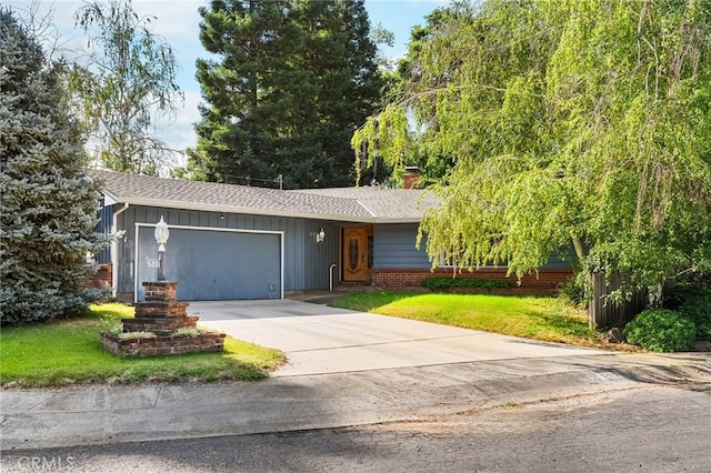 603 Reed Park Dr, Chico, CA 95926 - view of front of home with an attached garage, concrete driveway, a front yard, a shingled roof, and a chimney