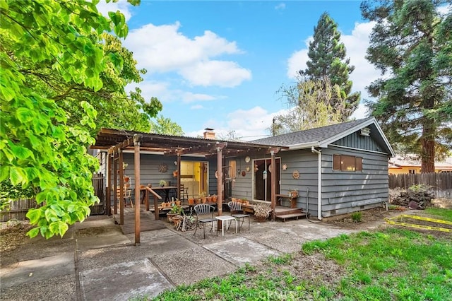 603 Reed Park Dr, Chico, CA 95926 - rear view of house featuring a patio area, a pergola, an outdoor living space, a chimney, and board and batten siding