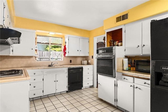 603 Reed Park Dr, Chico, CA 95926 - kitchen with black appliances, range hood, white cabinets, decorative backsplash, and light tile patterned floors