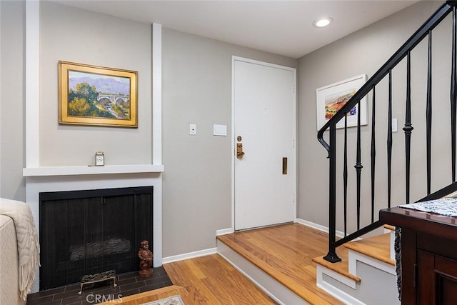 270 N Orange Grove Blvd, Pasadena, CA 91103 - foyer entrance featuring stairs, wood finished floors, recessed lighting, and a fireplace with flush hearth