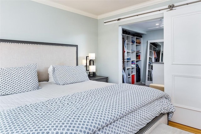 270 N Orange Grove Blvd, Pasadena, CA 91103 - bedroom featuring ornamental molding, a closet, a barn door, and a walk in closet