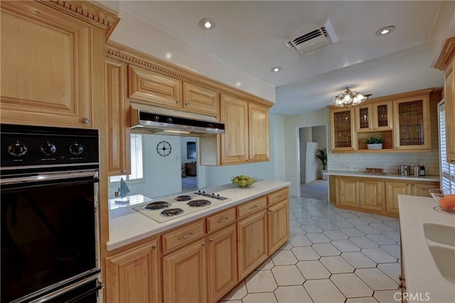 18342 Piper Pl, Yorba Linda, CA 92886 - kitchen with oven, white electric stovetop, under cabinet range hood, light countertops, and light brown cabinetry