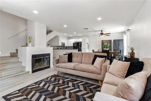 12411 Osborne St Unit 17, Pacoima, CA 91331 - living room with stairway, a ceiling fan, recessed lighting, and light wood-type flooring