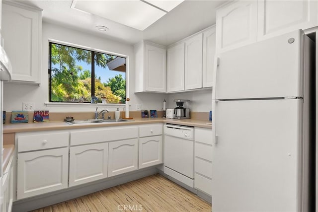 922 Avenida Majorca Unit O, Laguna Woods, CA 92637 - kitchen with white appliances, white cabinets, light countertops, and light wood-style floors
