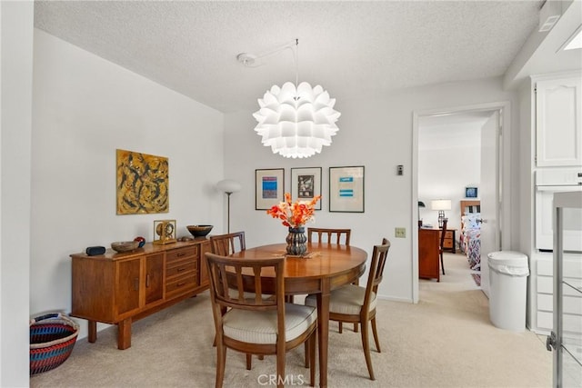 922 Avenida Majorca Unit O, Laguna Woods, CA 92637 - dining area featuring light carpet, a textured ceiling, and a chandelier