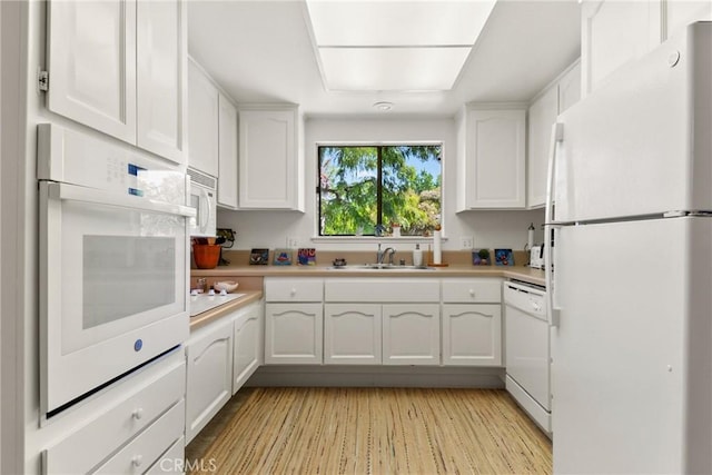922 Avenida Majorca Unit O, Laguna Woods, CA 92637 - kitchen with white appliances, white cabinetry, and light countertops