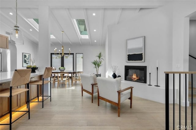 2708 Via Elevado, Palos Verdes Estates, CA 90274 - living room with a glass covered fireplace, a skylight, light wood-style floors, a chandelier, and recessed lighting