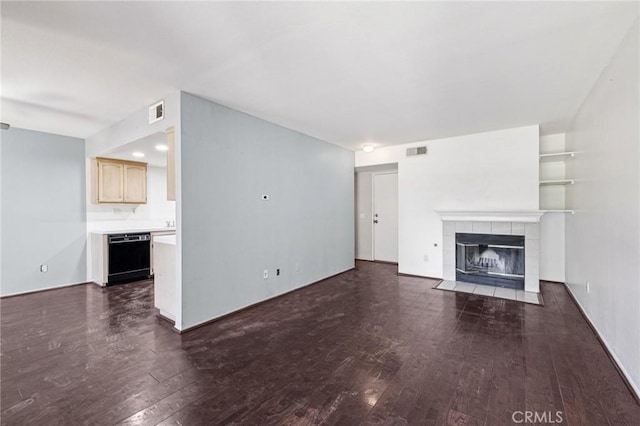 1832 E E Ave J2, Unit 2, Lancaster, CA 93535 - unfurnished living room with dark wood-style flooring and a tiled fireplace