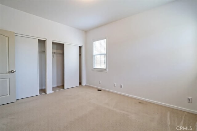 8656 Harvest Pl, Rancho Cucamonga, CA 91730 - unfurnished bedroom featuring multiple closets and light carpet