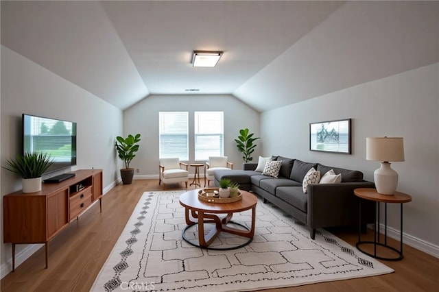 8656 Harvest Pl, Rancho Cucamonga, CA 91730 - living room featuring vaulted ceiling and light wood-type flooring