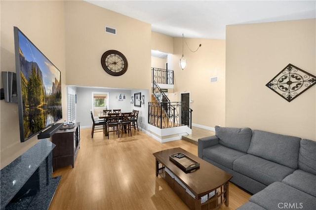 2405 E Alicia St, West Covina, CA 91792 - living room with stairs, wood finished floors, and a towering ceiling
