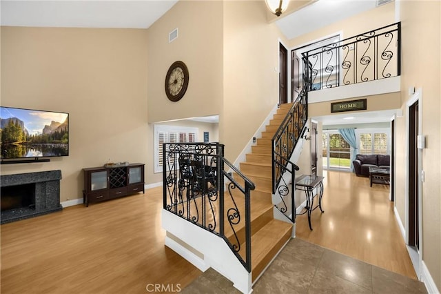 2405 E Alicia St, West Covina, CA 91792 - stairs featuring a towering ceiling, wood finished floors, and a premium fireplace