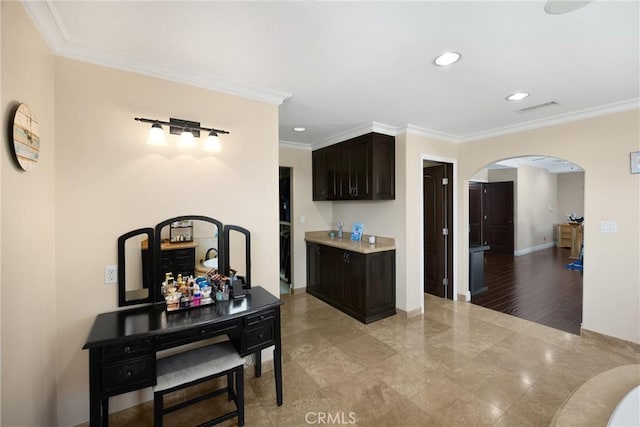 2405 E Alicia St, West Covina, CA 91792 - kitchen with arched walkways, ornamental molding, recessed lighting, light countertops, and dark brown cabinets