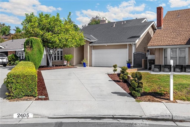 2405 E Alicia St, West Covina, CA 91792 - view of front of house with an attached garage, concrete driveway, stucco siding, and a gate