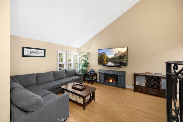 2405 E Alicia St, West Covina, CA 91792 - living room with high vaulted ceiling, a fireplace, and light wood finished floors