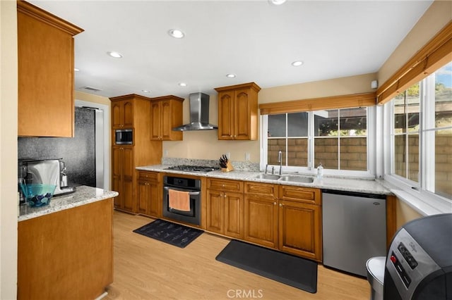 2405 E Alicia St, West Covina, CA 91792 - kitchen featuring appliances with stainless steel finishes, wall chimney range hood, light wood-type flooring, brown cabinetry, and recessed lighting