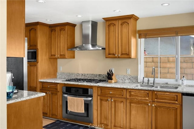 2405 E Alicia St, West Covina, CA 91792 - kitchen featuring appliances with stainless steel finishes, wall chimney range hood, brown cabinets, light stone countertops, and recessed lighting