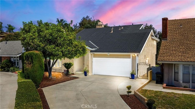 2405 E Alicia St, West Covina, CA 91792 - view of front facade with driveway, a chimney, a gate, an attached garage, and roof with shingles