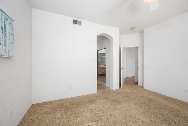 41791 Corte Lara, Temecula, CA 92592 - spare room featuring arched walkways, carpet, ceiling fan, and a smoke detector