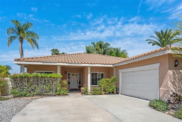 41791 Corte Lara, Temecula, CA 92592 - view of front of home featuring a garage, stucco siding, a tile roof, and concrete driveway