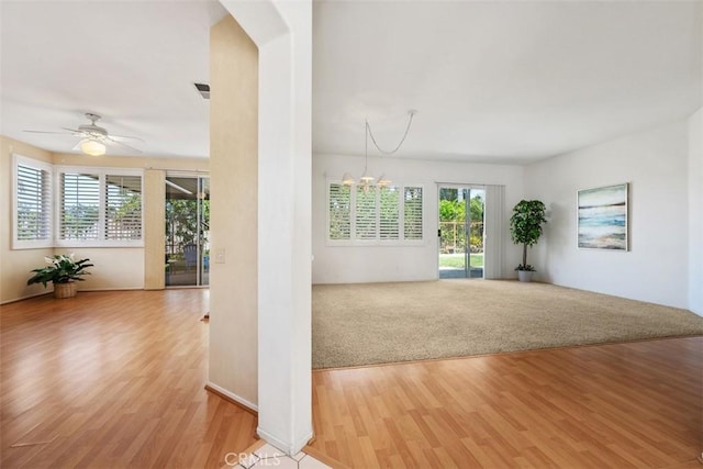 41791 Corte Lara, Temecula, CA 92592 - spare room featuring light wood finished floors, a ceiling fan, a chandelier, and arched walkways