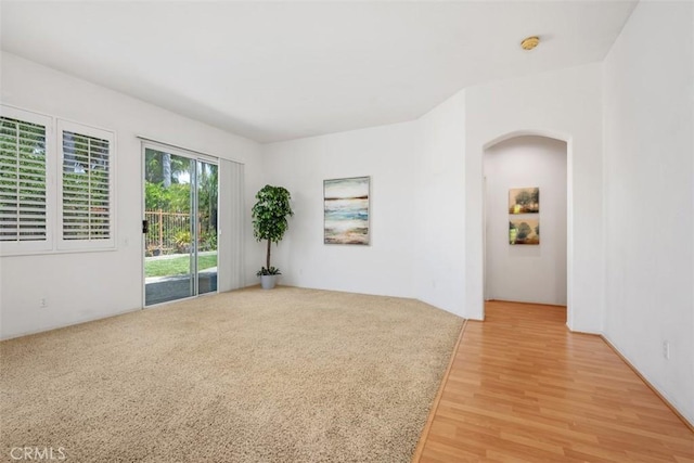 41791 Corte Lara, Temecula, CA 92592 - empty room with light wood-type flooring, arched walkways, and a smoke detector