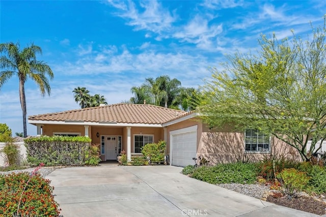 41791 Corte Lara, Temecula, CA 92592 - view of front of home featuring a garage, concrete driveway, a tiled roof, and stucco siding