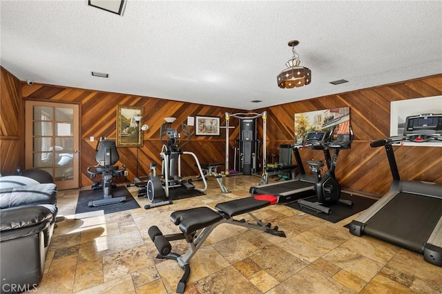 525 S Ardmore Ave Unit 257, Los Angeles, CA 90020 - workout area featuring wood walls, a textured ceiling, and stone tile floors