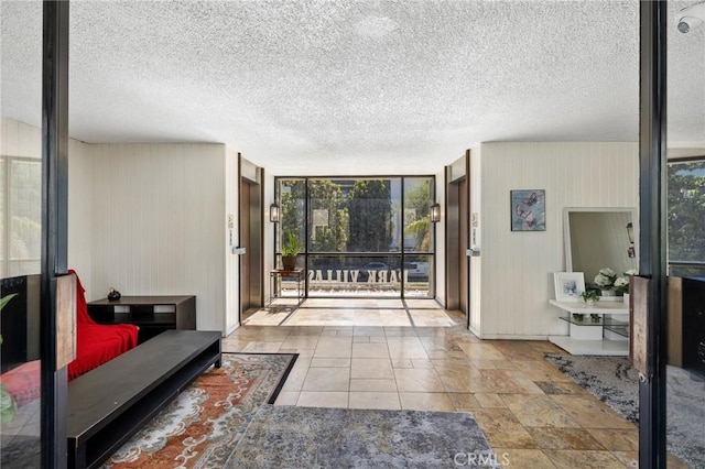 525 S Ardmore Ave Unit 257, Los Angeles, CA 90020 - living room featuring a textured ceiling and wood walls
