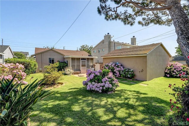 4750 W 191st St, Torrance, CA 90503 - rear view of house with a sunroom, a yard, and stucco siding