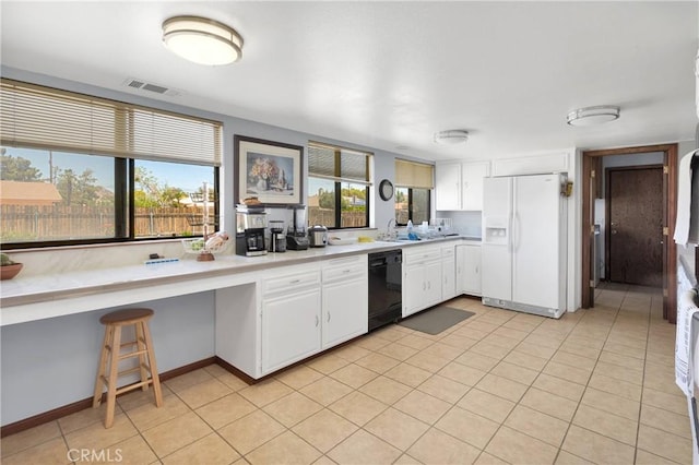 19678 Red Feather Rd, Apple Valley, CA 92307 - kitchen featuring white fridge with ice dispenser, dishwasher, light countertops, white cabinetry, and light tile patterned floors